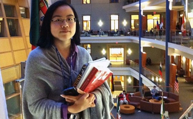 Lydia Brown holding books inside the business school