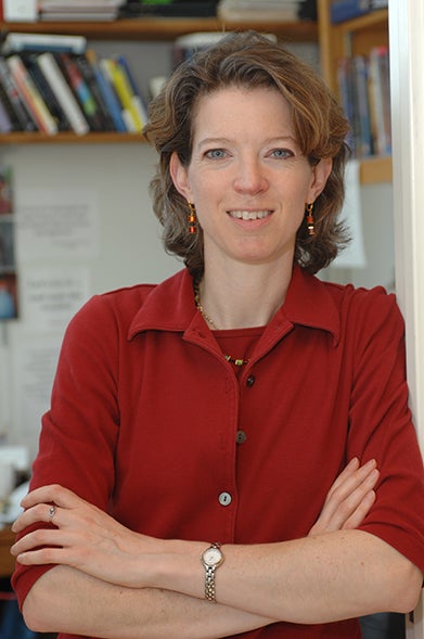 Biology professor Heidi Elmendorf smiling with her arms crossed.