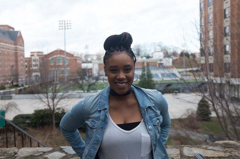 Jada Bullen smiles for the camera in front of the football field.