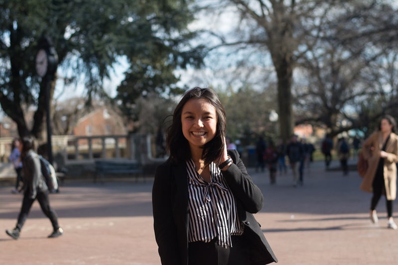 Tiffany Lam smiles at the camera from Red Square on a windy day