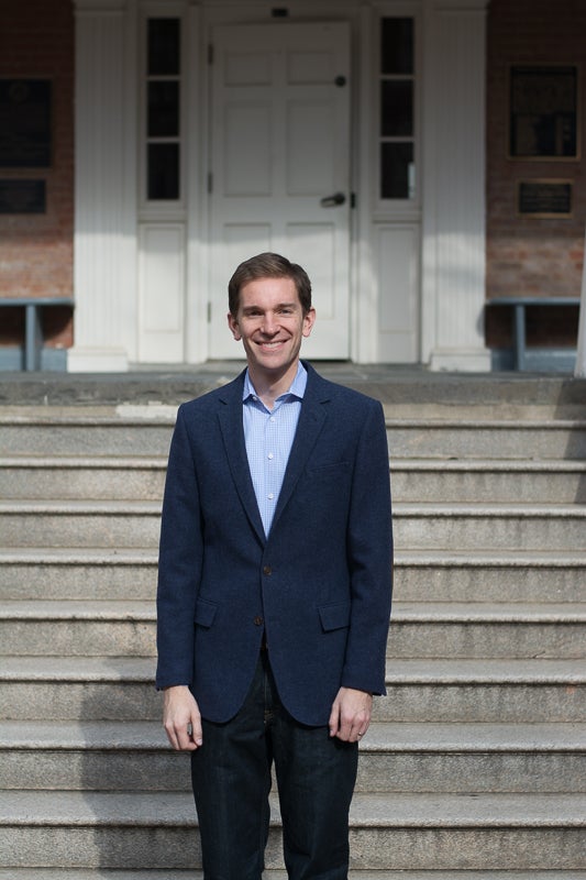 Professor Jonathan Ladd smiles for the camera in front of steps.