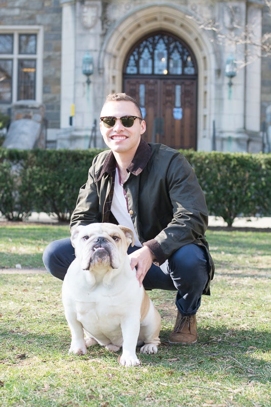 Matt Censullo smiles for the camera next to a dog.