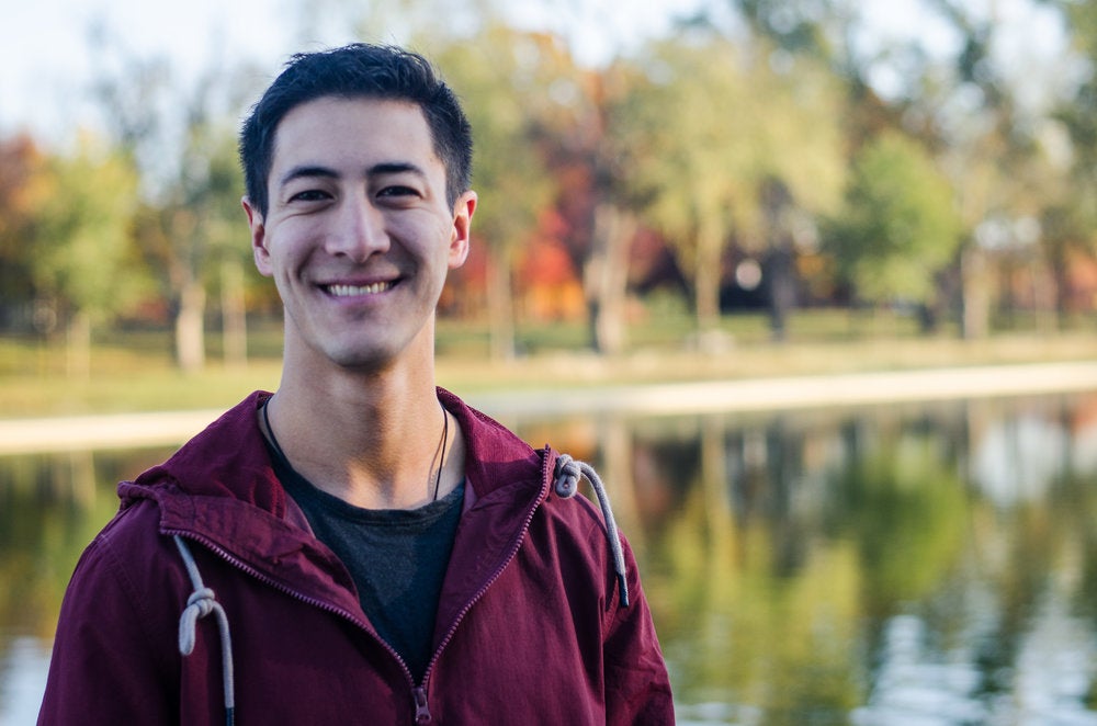 Greg Jarvis smiles for the camera in front of a body of water.