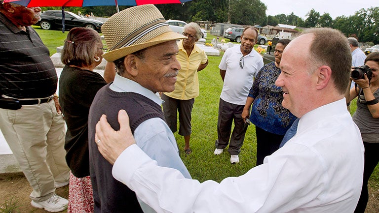 President John J. DeGioia shakes hands with GU 272 descendant Johnny Harris in Louisiana