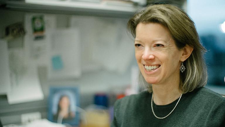 Heidi Elmendorf smiling in her office.