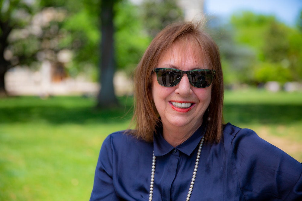 Elizabeth Velez smiles for the camera on the lawn.