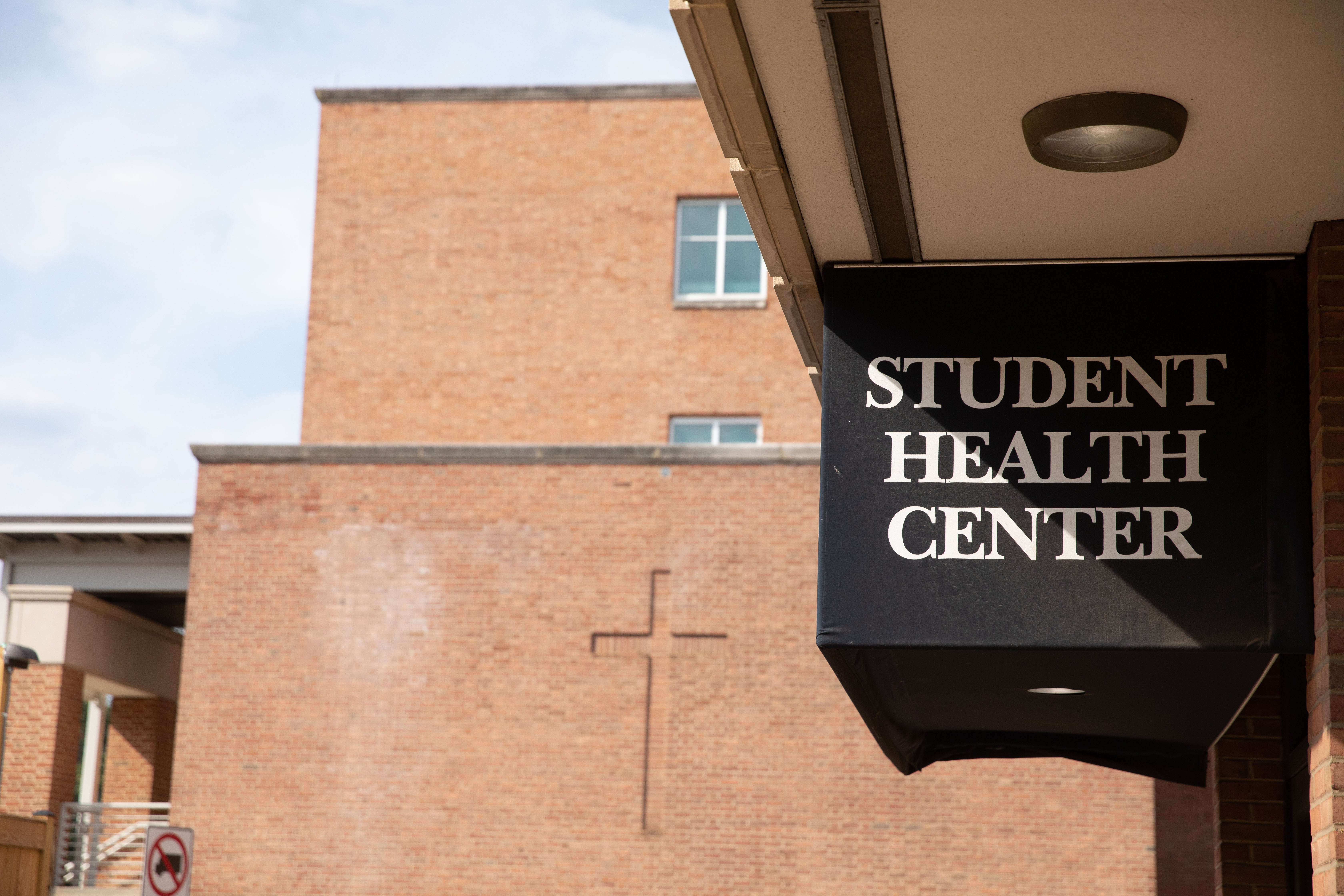 A sign hangs outside the Student Health Center