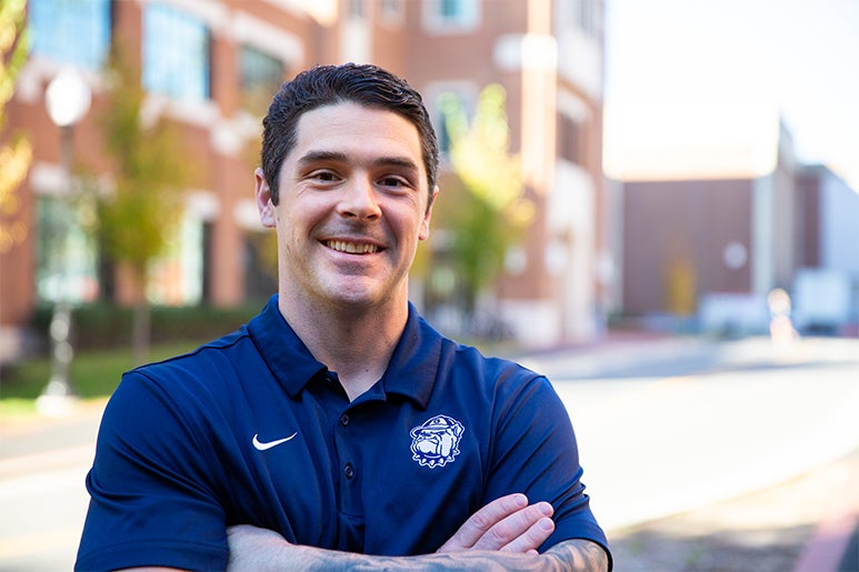 Sean Cooke outside with buildings behind him