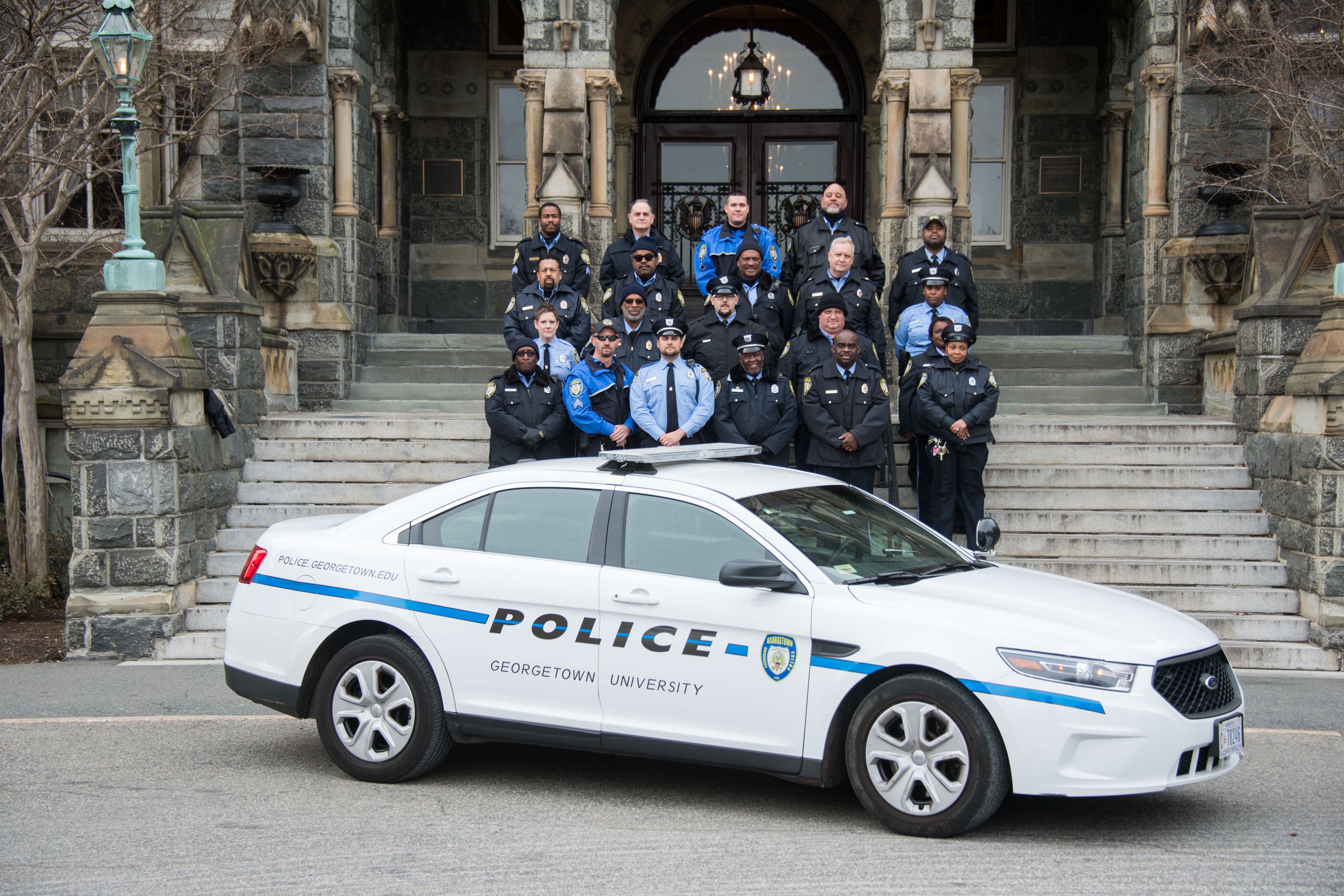 GUPD officers pose in front of Healy Hall