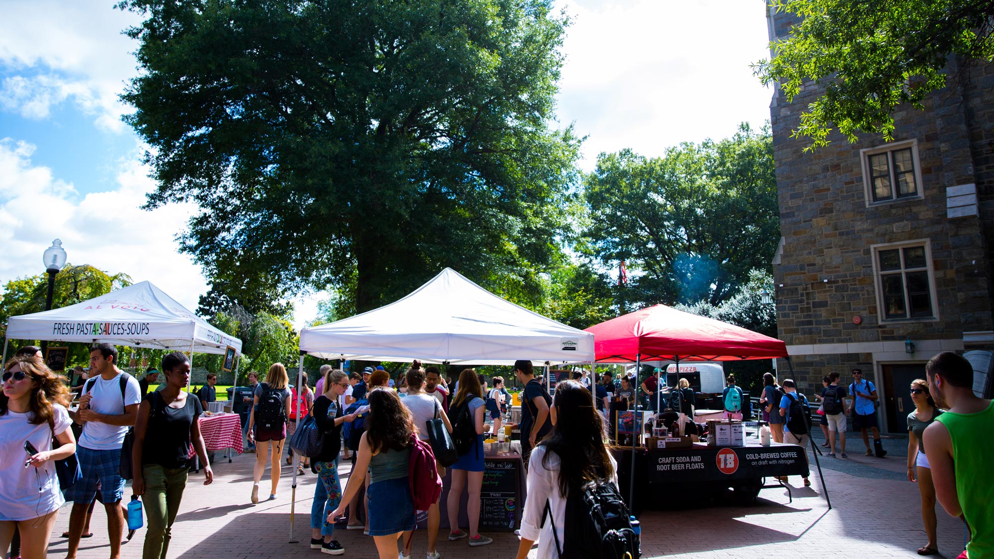 Local food vendors set up tents on campus to offer dishes to students during the weekly Farmer's Market.