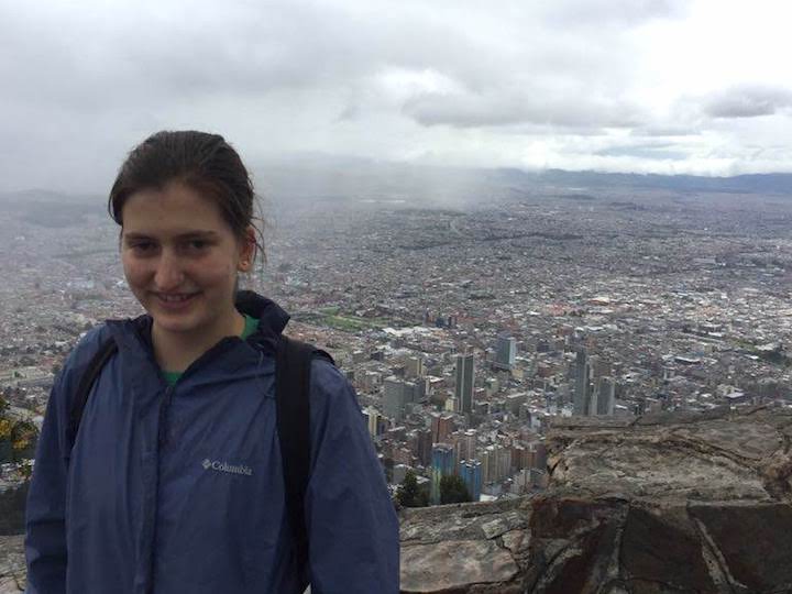 A student stands for a photo while abroad in Bogota.