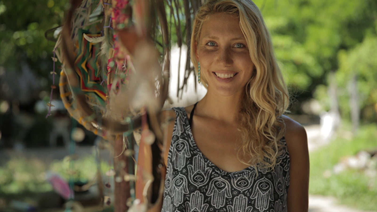 Emi Koch standing outside with dream catcher