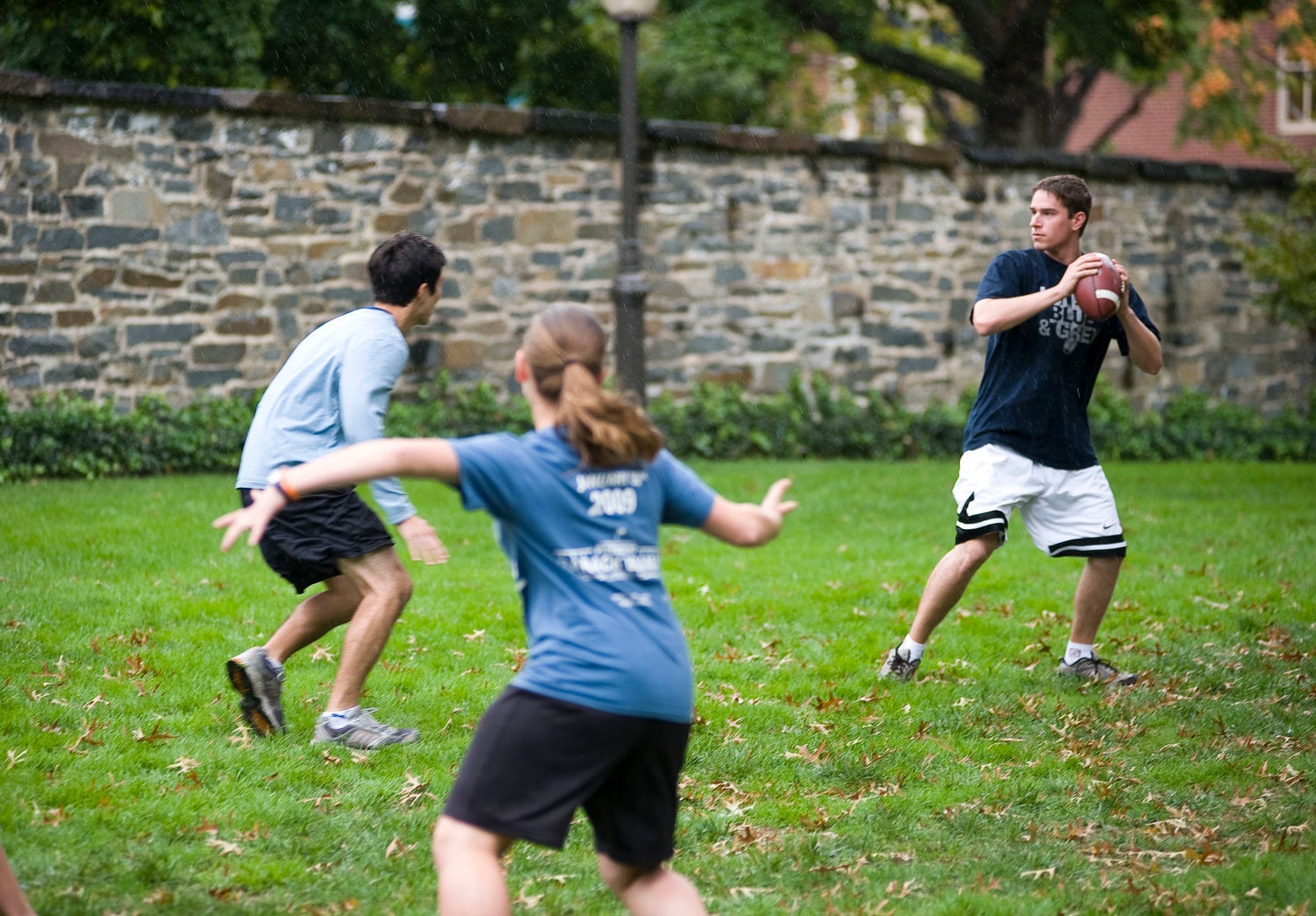 Students play football on the lawn