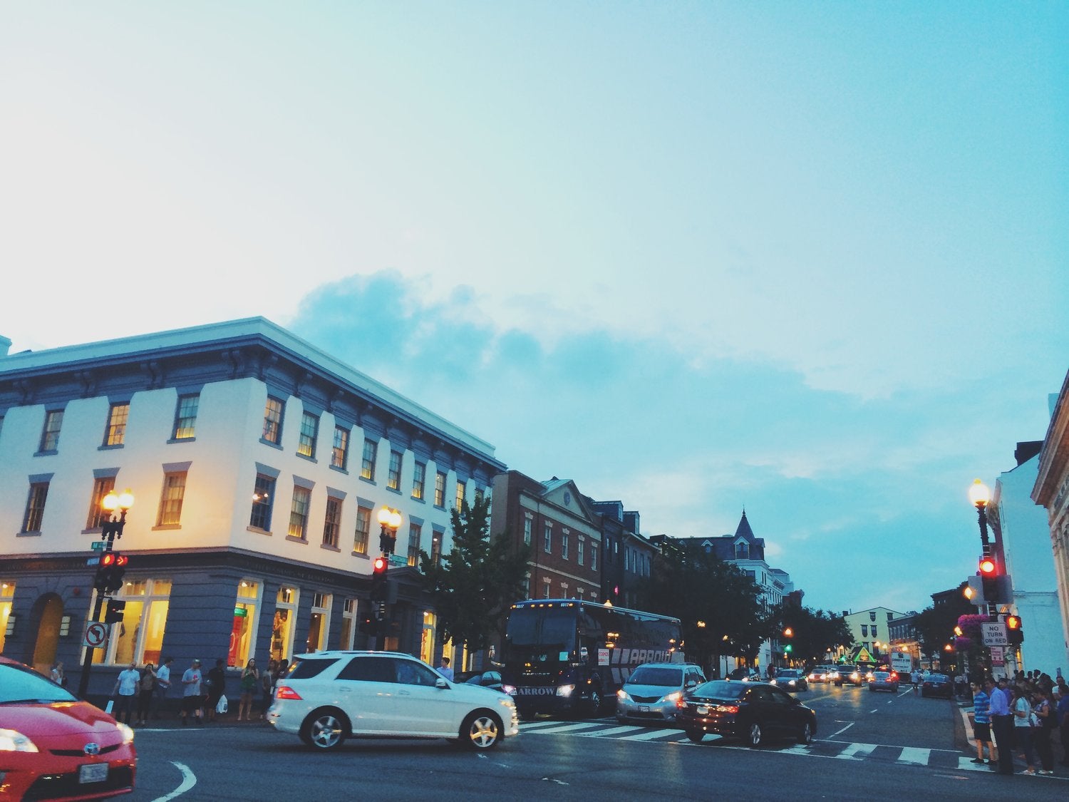 Crowds walk down M Street in the evening