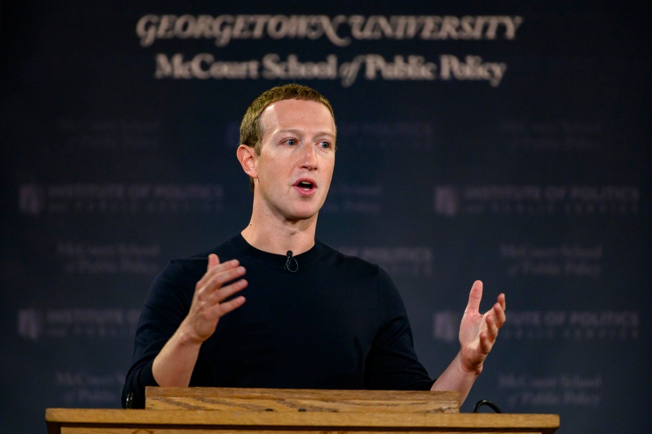 Mark Zuckerberg speaks at a lectern with a blue banner displaying "Georgetown University McCourt School of Public Policy.