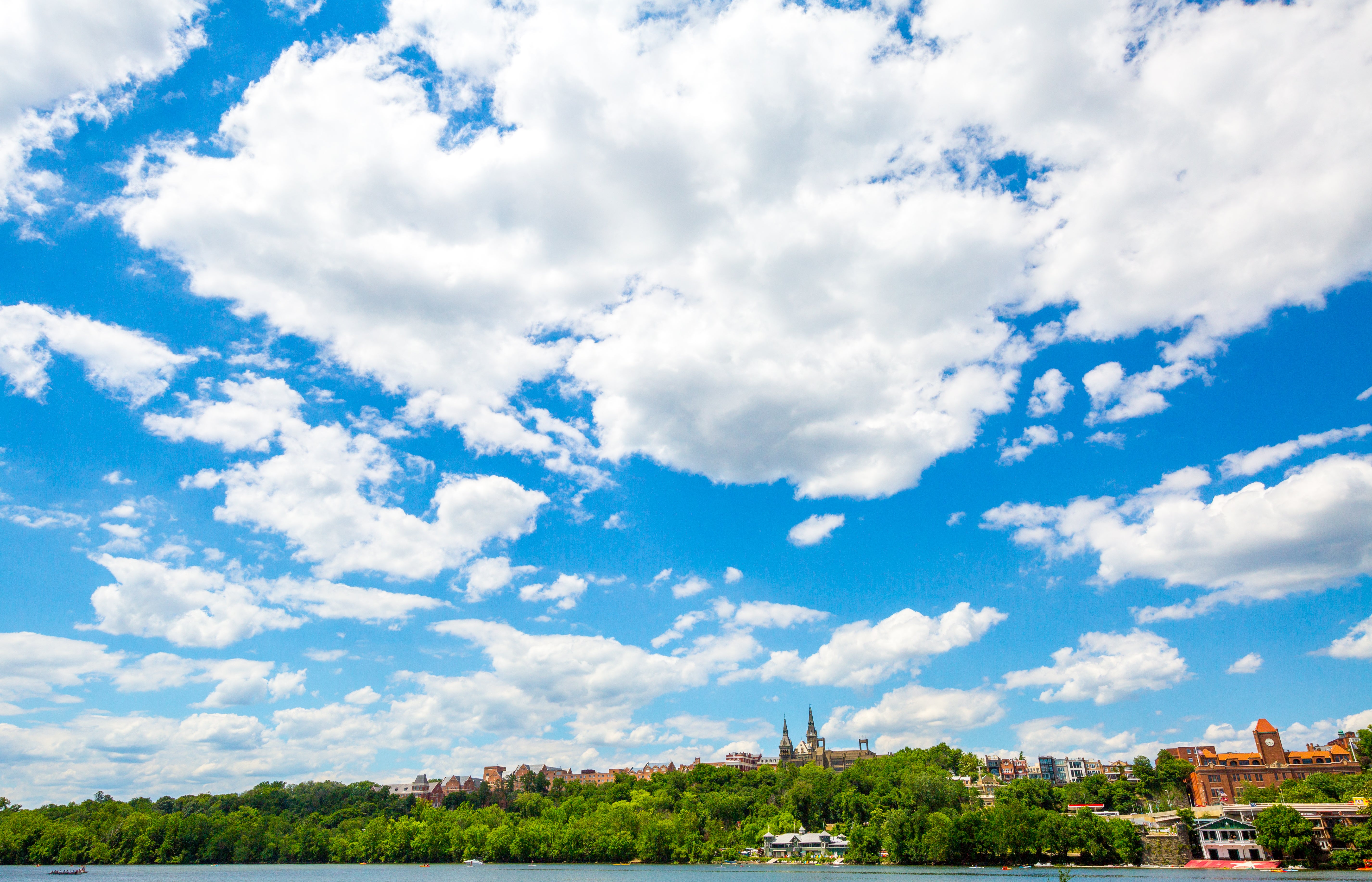 The Georgetown University campus outlines the bottom half of the photo, and is framed by a large, blue sky.