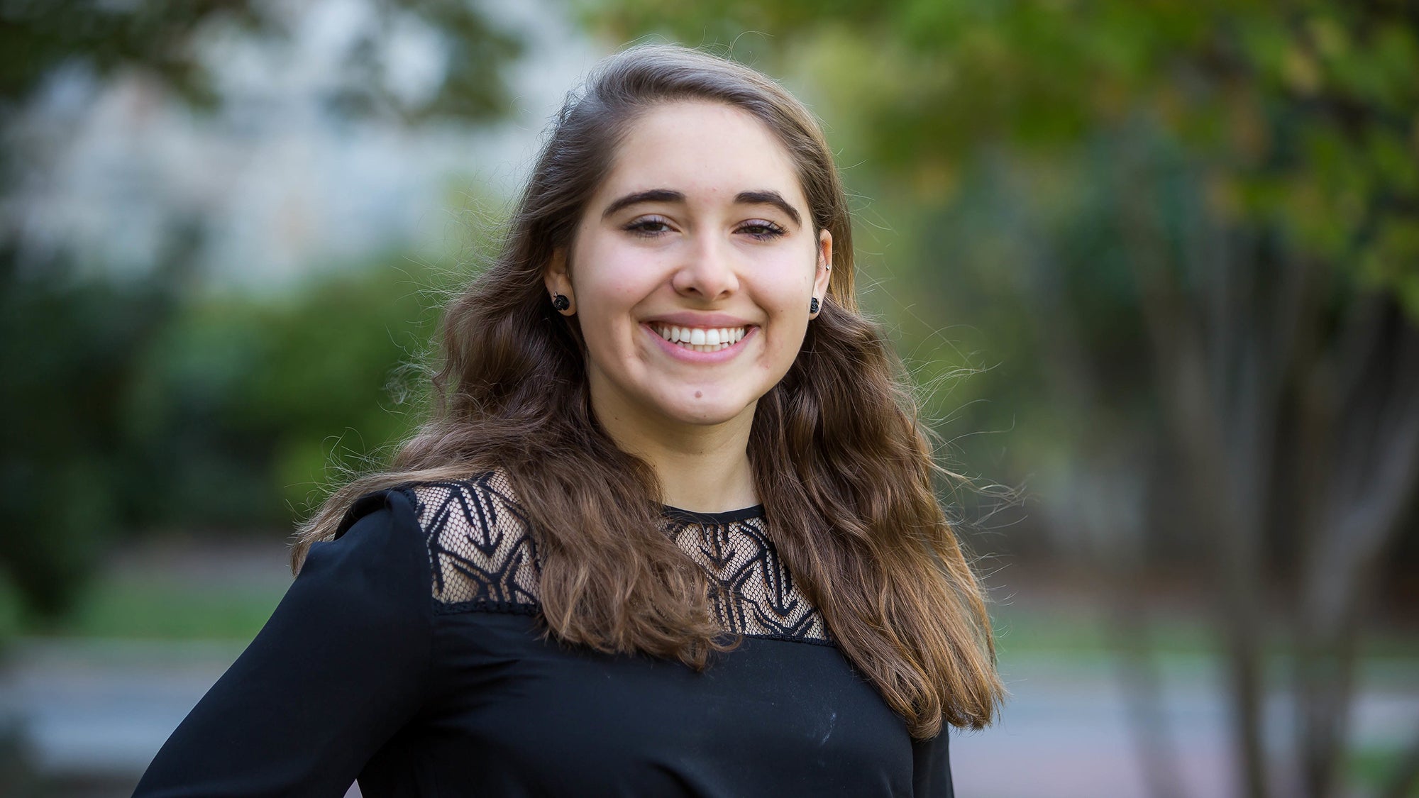 Emma Berk outside with trees behind her