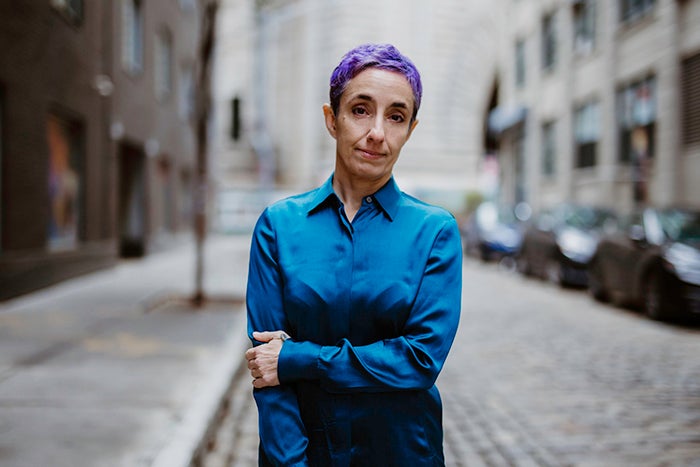 Quill Kukla standing on a street with buildings behind her