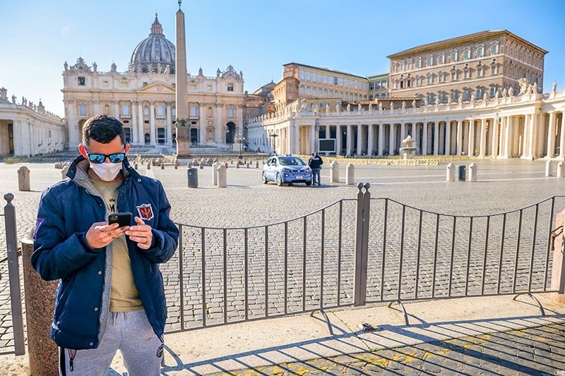 A young man wears a protective face mask.