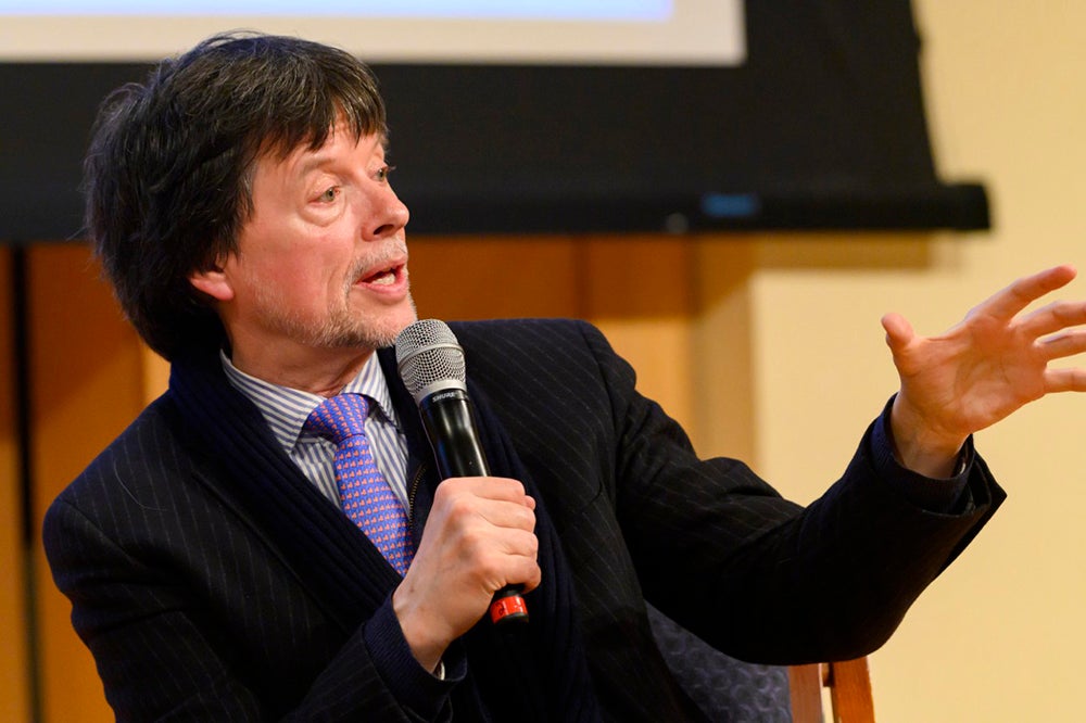 Ken Burns gesturing and holding a microphone