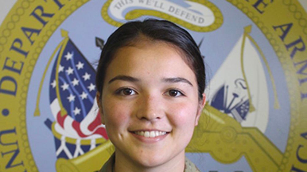 Katherine Keady in front of the Army seal