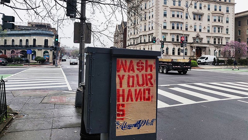 Sign on street that says Wash Your Hands Absurdly Well