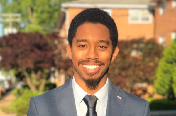 Marvin Wiley outside with vegetation and a house in the background