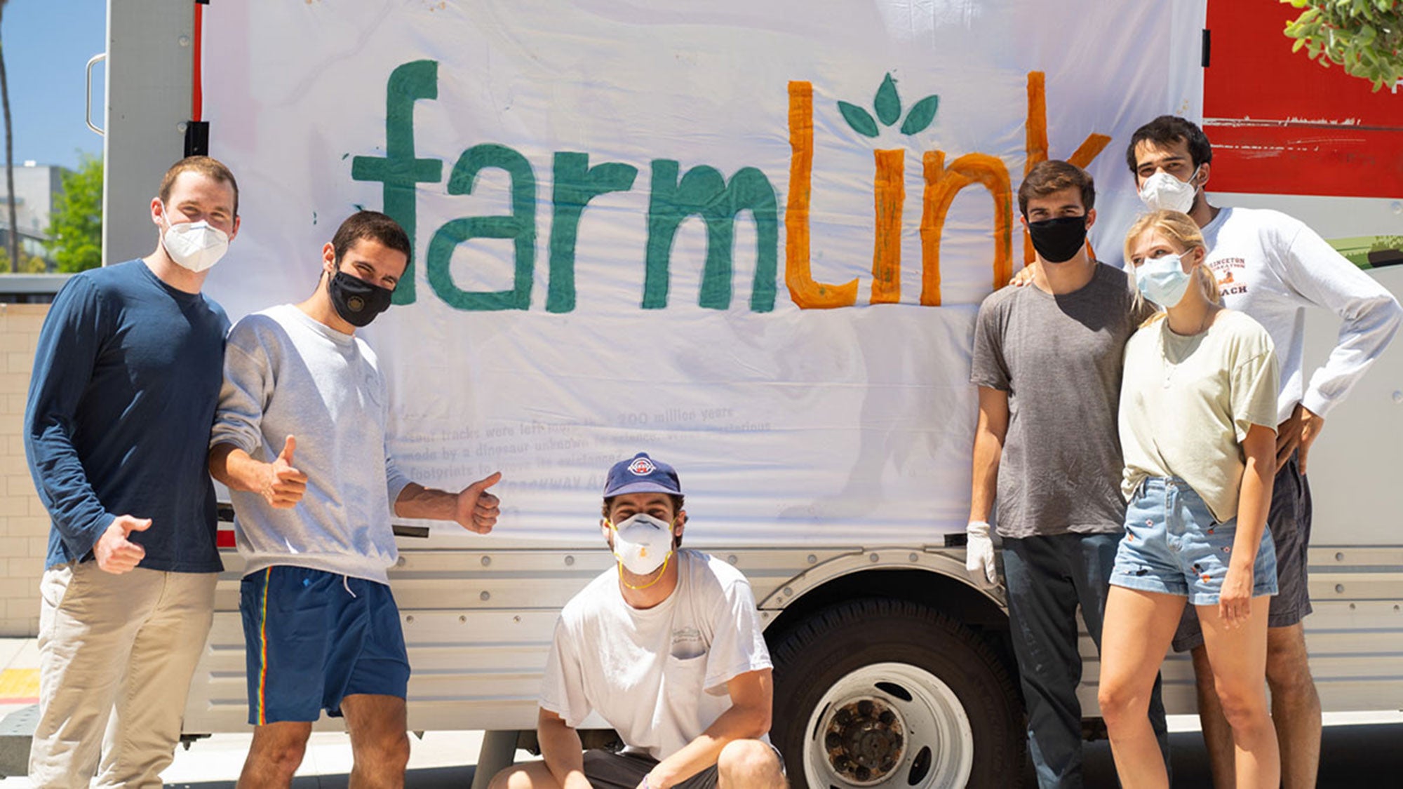 Six students stand in front of a banner that reads FarmLink.