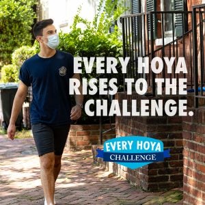 A student walks down the street with a mask on with the text "Every Hoya Rises to the Challenge."