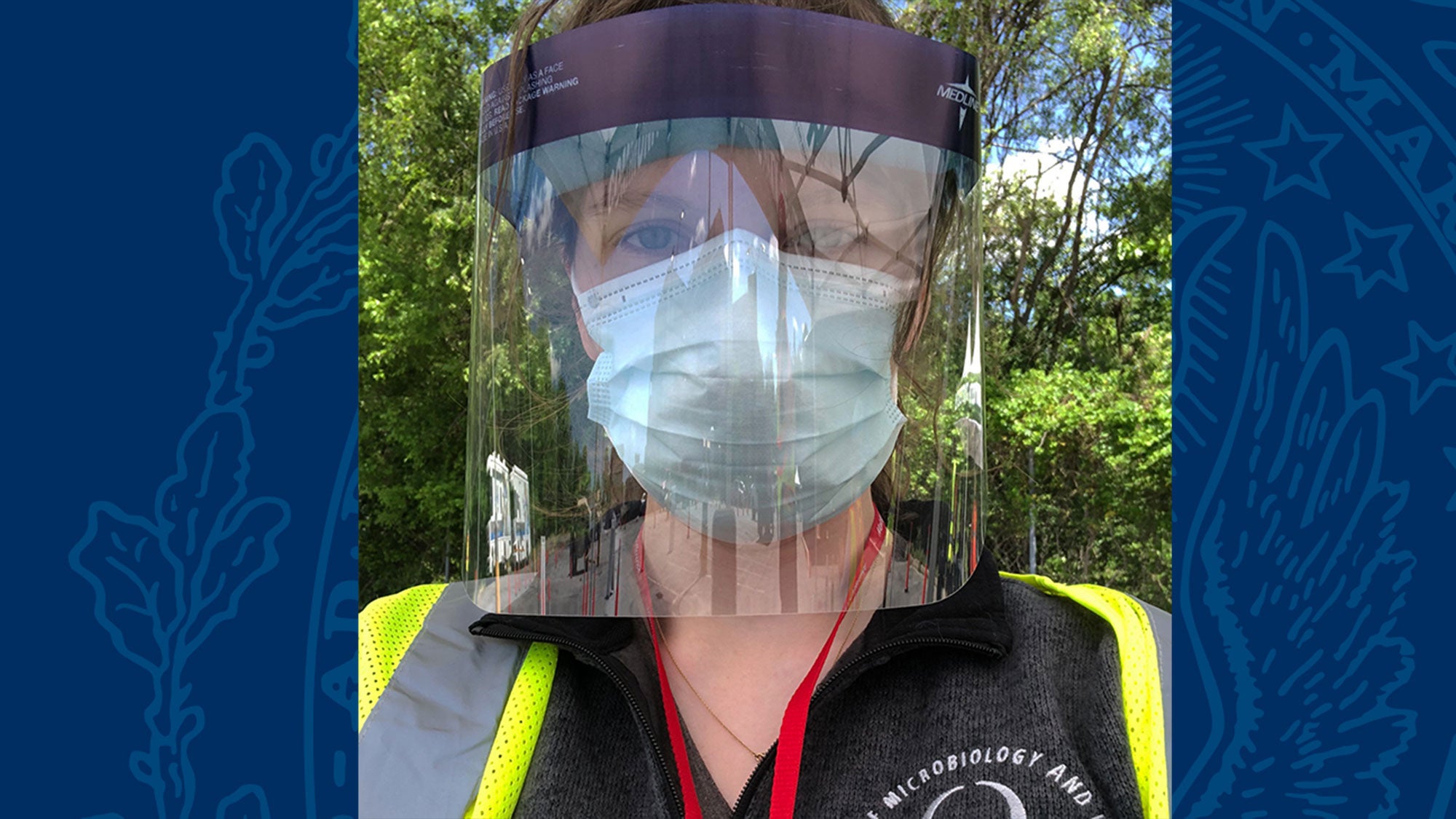 Suzie Stephenson wears a protective face mask and shield.