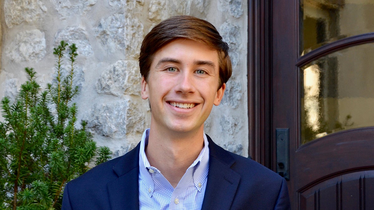 Headshot of Alex Heintze wearing a blue blazer