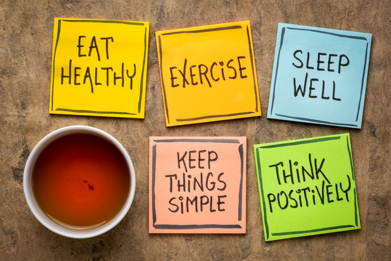 Tea and post-its reading, "Eat Healthy," "Exercise," "Sleep Well," "Keep Things Simple" and "Think Positively"