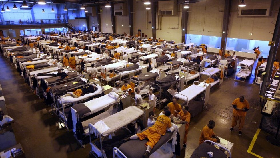 Several hundred inmates crowd the gymnasium at San Quentin prison in San Quentin, Calif.