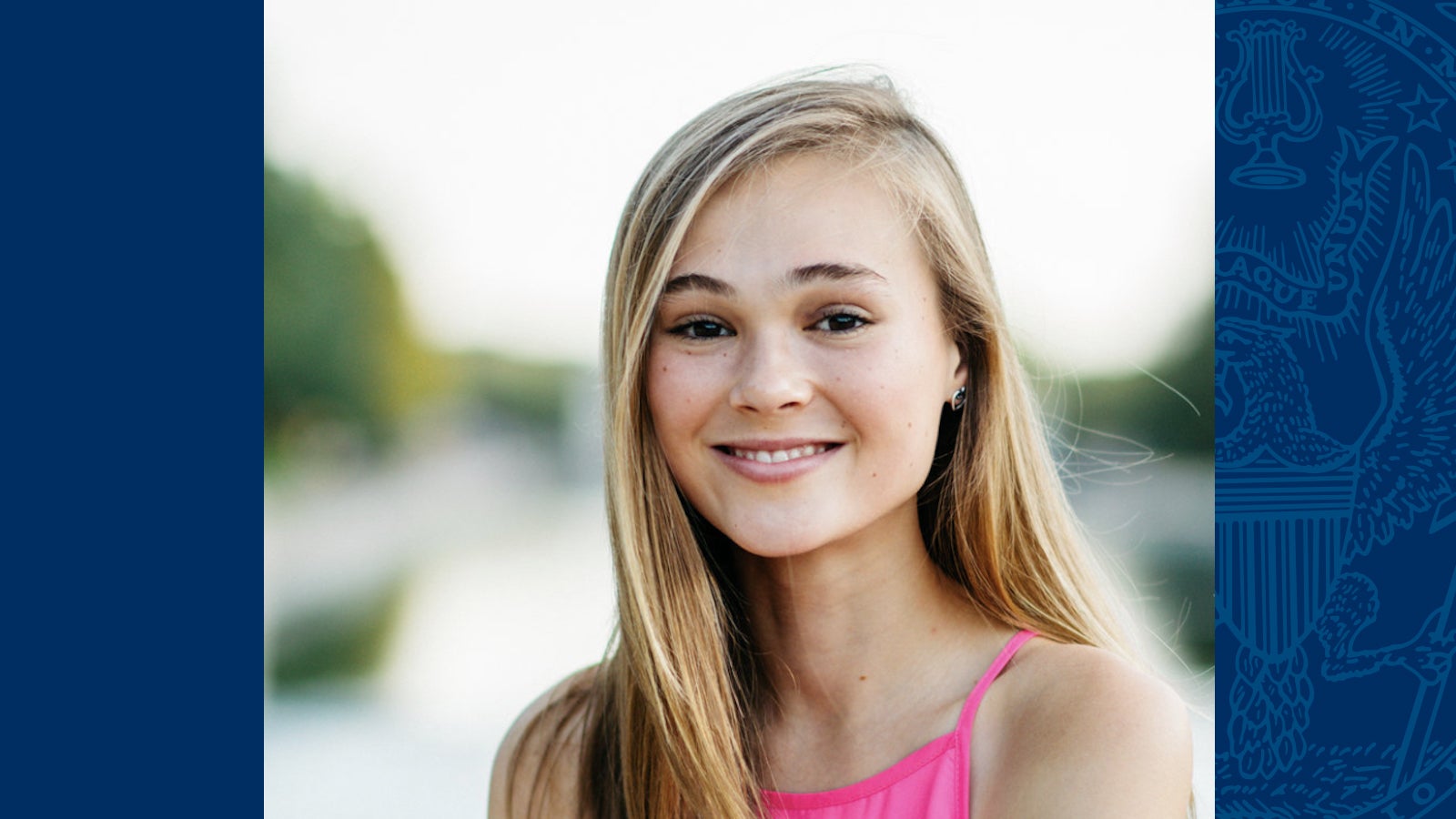 Jordan Kramer headshot outdoors wearing a pink shirt