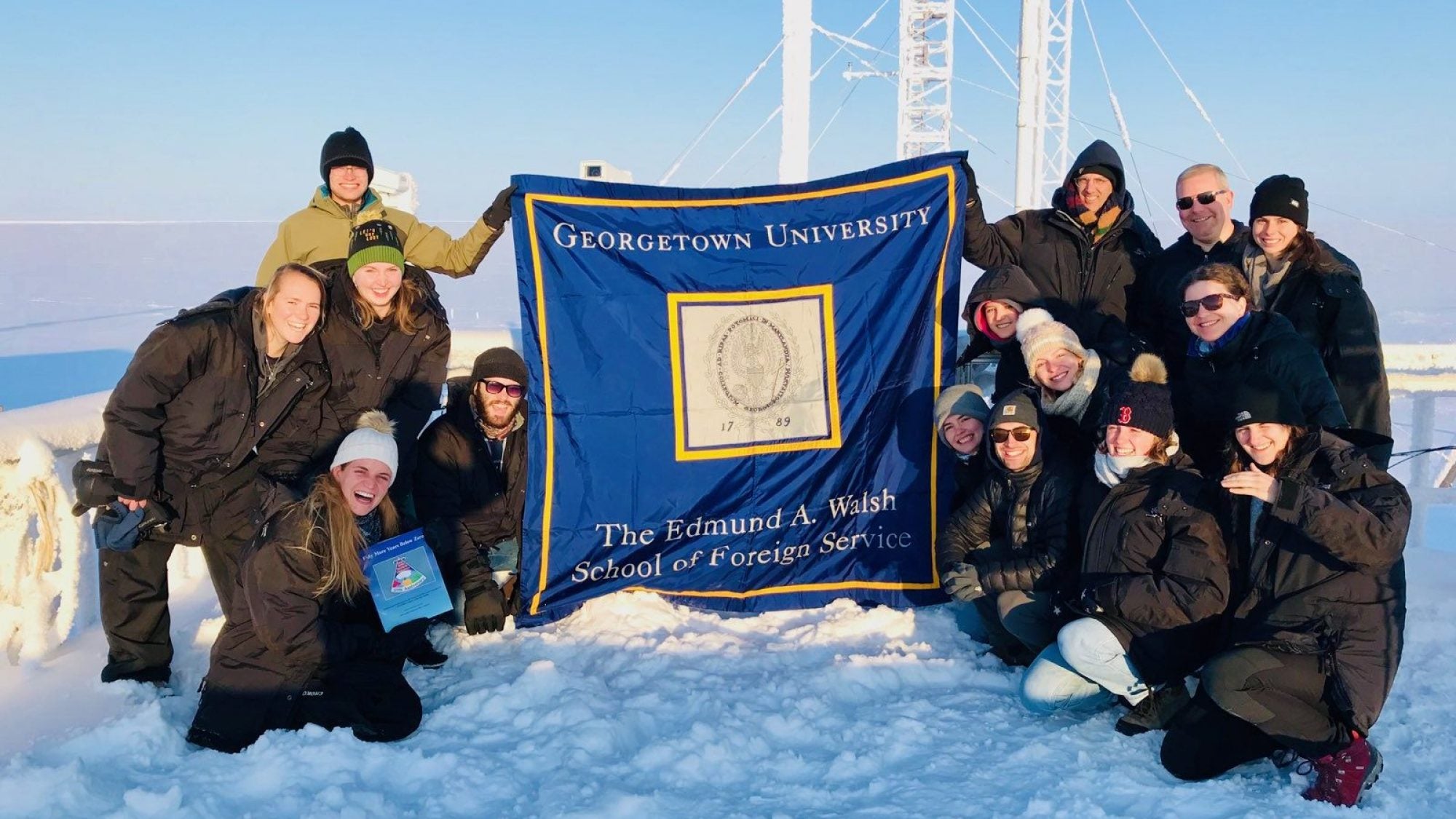 Britt and his classmates and professors atop a NOAA climate monitoring facility in the sub-zero temperatures of Utqiagvik, Alaska.