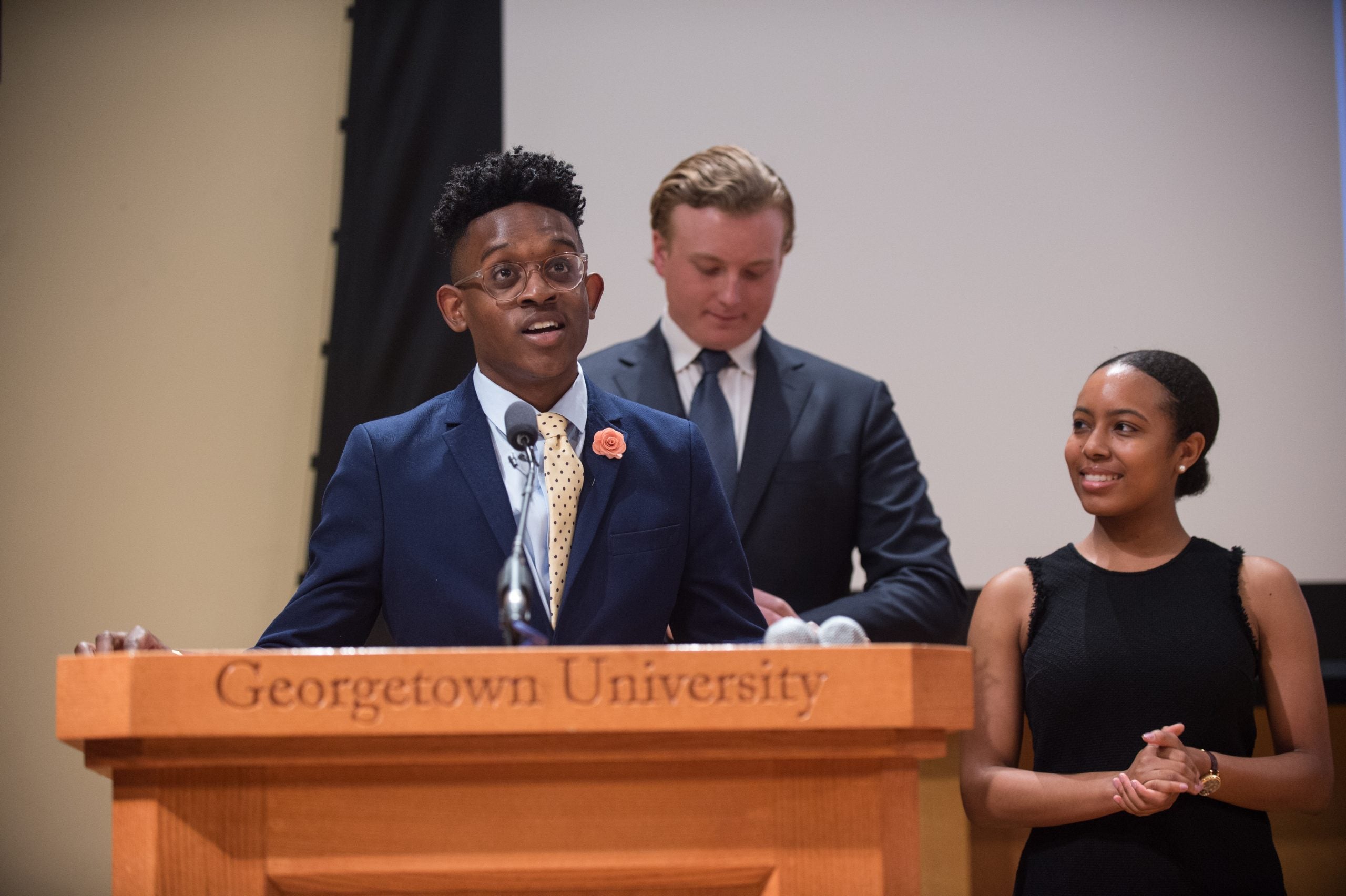 Kendell Long stands a podium