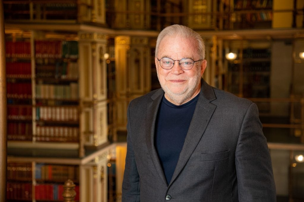 Jim Wallis stands in front of bookshelves