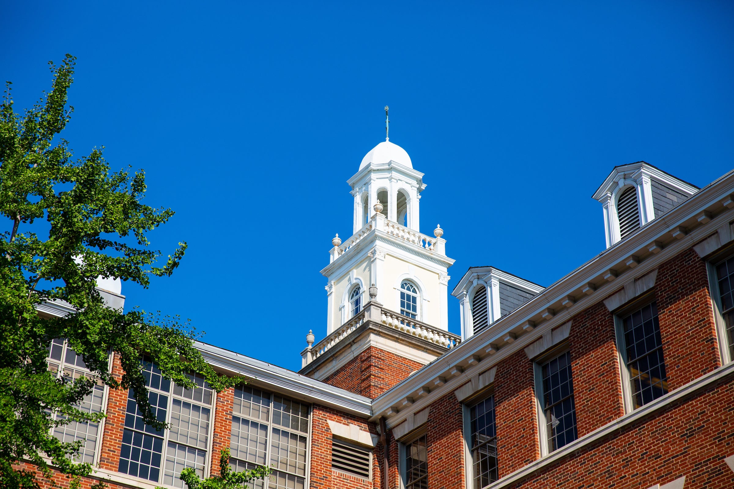 Bell tower at the top of the Med Dent building against a blue sky