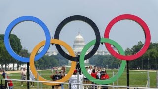 Capitol Building in the background of intersection five large Olympic rings