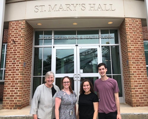 Leaders of the CURA pre-orientation program stand in front of St. Mary's Hall