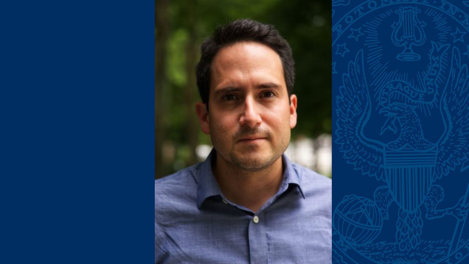 Headshot of Alvaro Bedoya wearing a blue shirt on a blue background