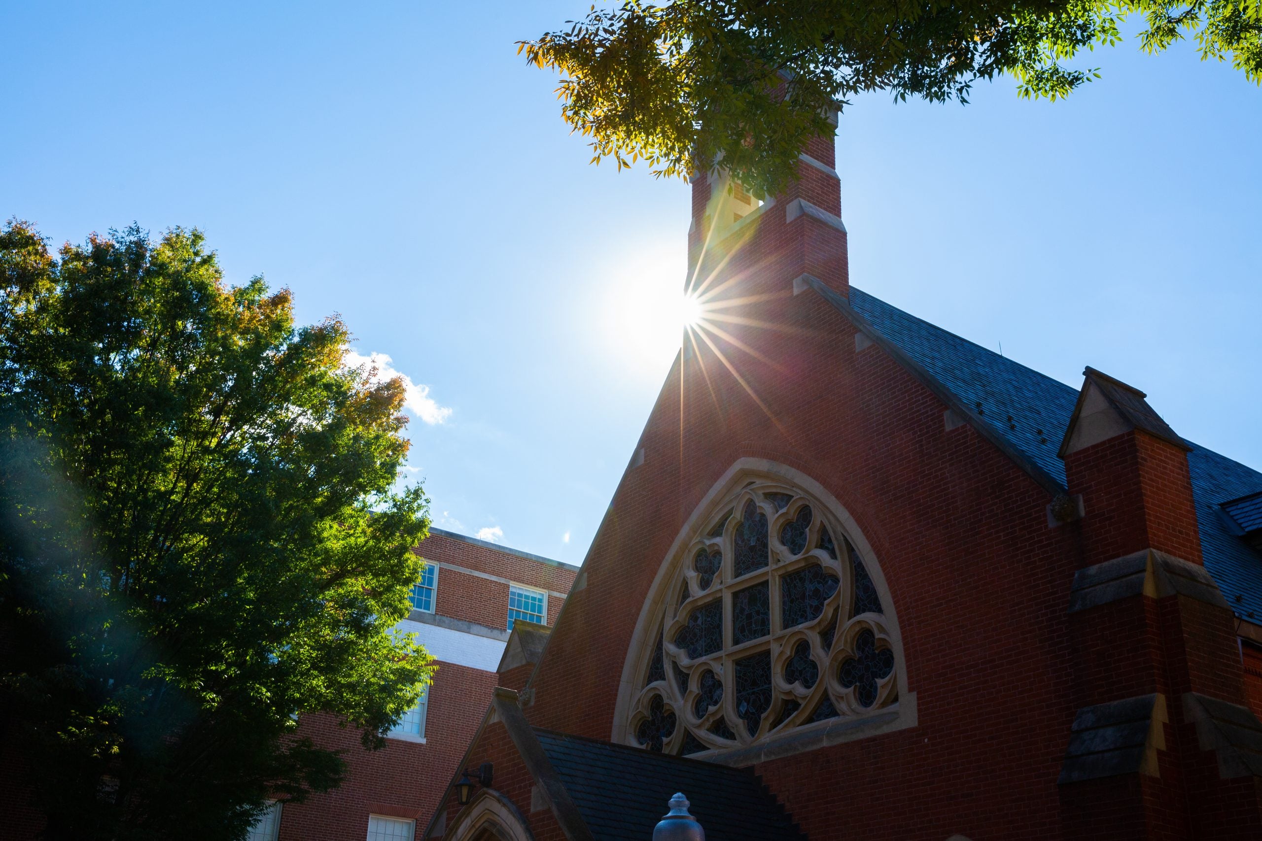 Sun flare behind the tower of Dahlgren Chapel