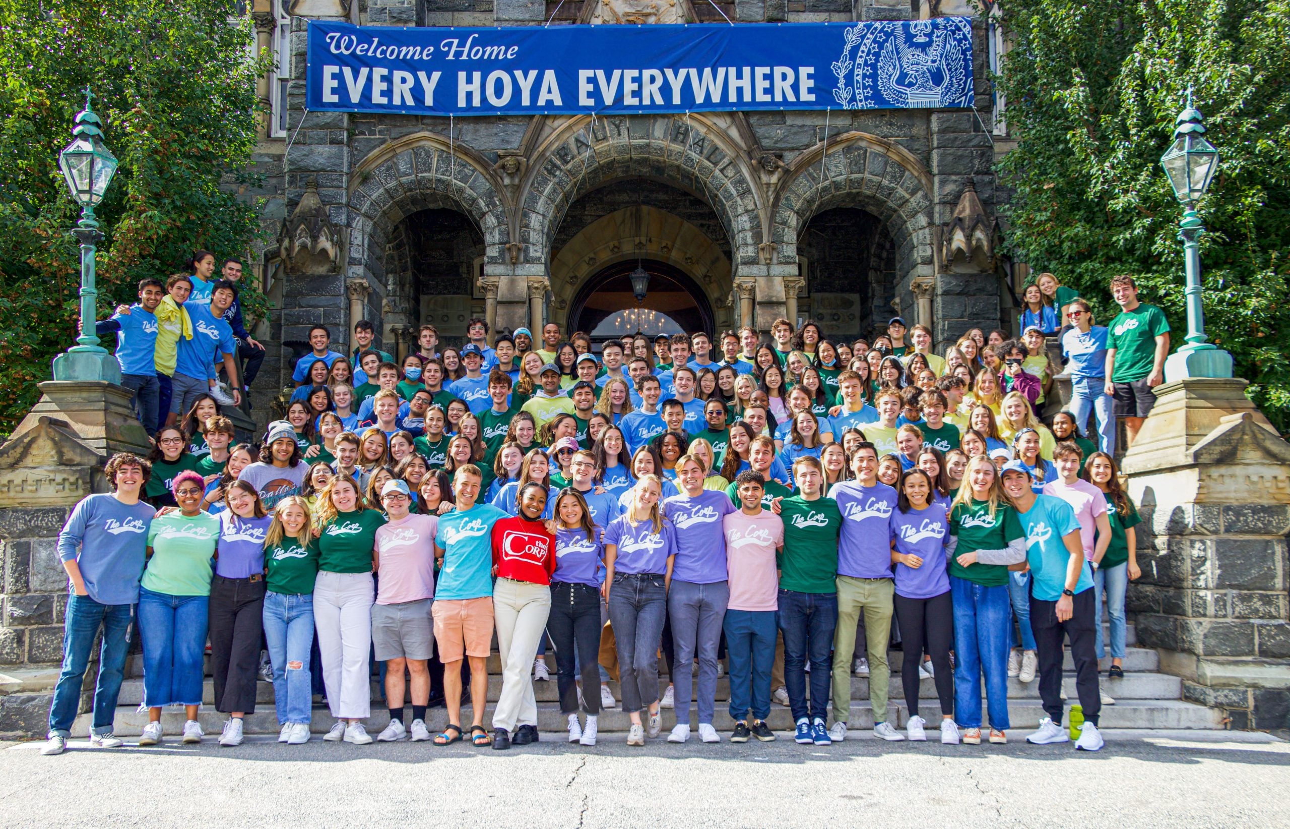 Group photo of Corp employees wearing Corp T-shirts on Healy steps