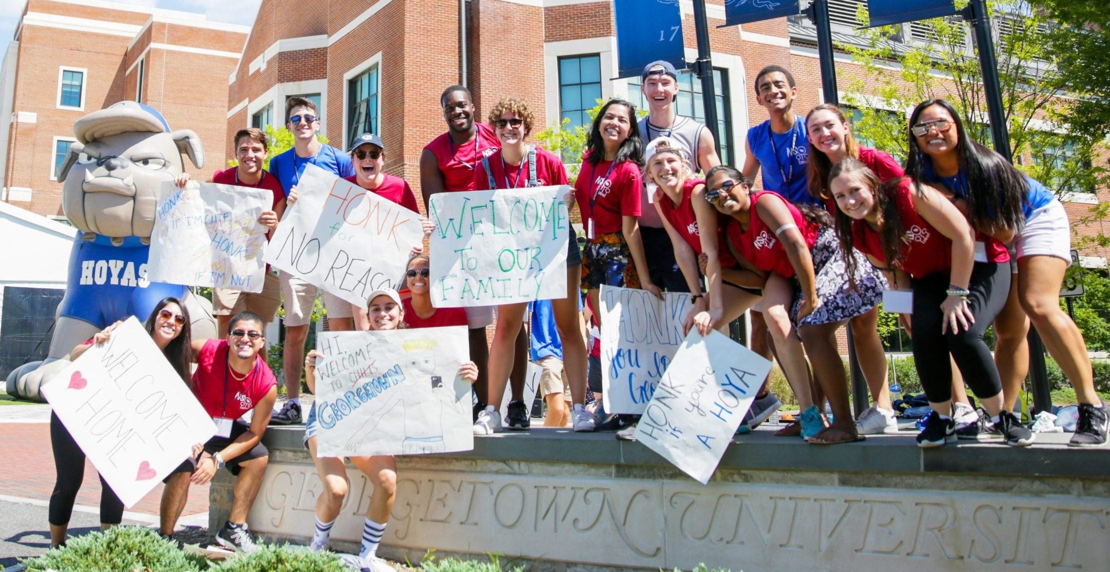 Group of students with welcoming signs