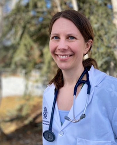 Headshot of Cassie Bronson outside wearing a white coat and stethoscope