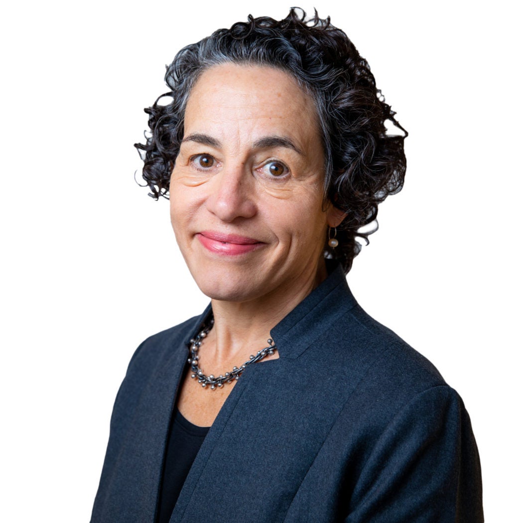 A headshot of McCourt School Dean Marcia Cancian, who wears a blue suit.