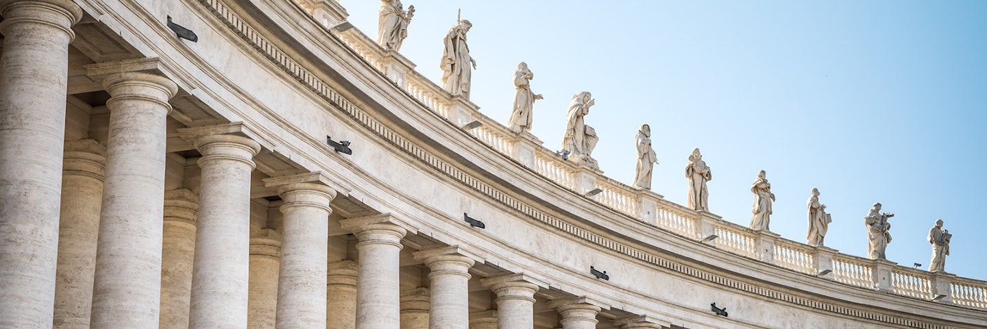 An image of white columns at the Vatican in Rome