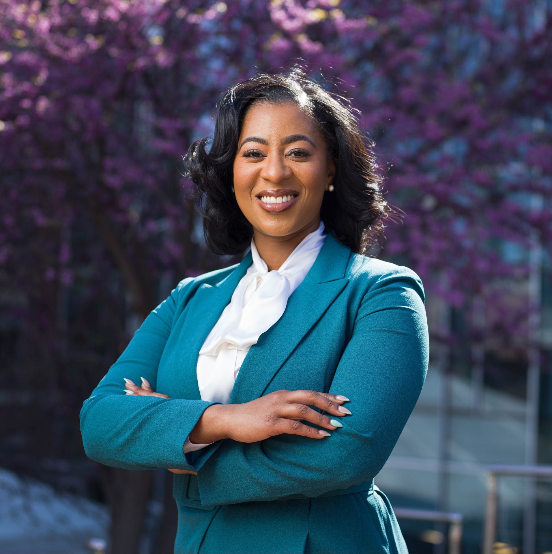 Ella Washington stands in front of a blooming tree