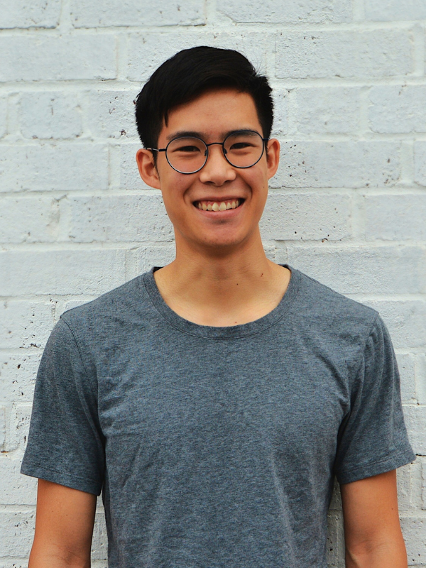 An image of Phil Wong, an alumnus and creator of a food startup, wearing a gray T-shirt and glasses.