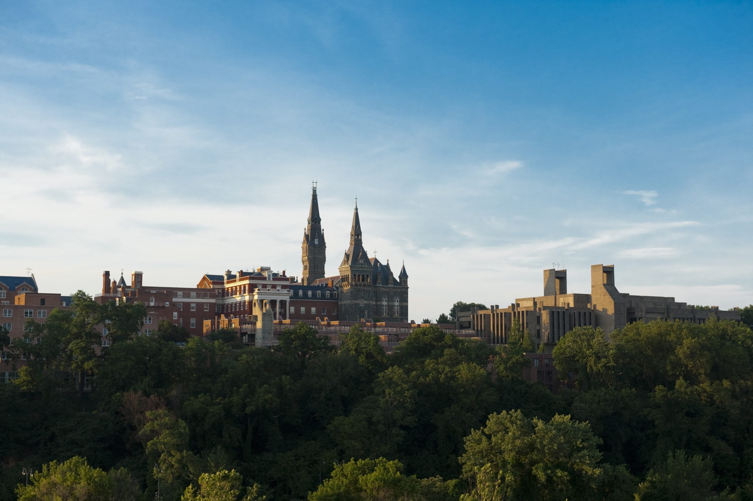 An aerial shot of Georgetown's campus, centered on the tall spires of Georgetown's Healy Hall.